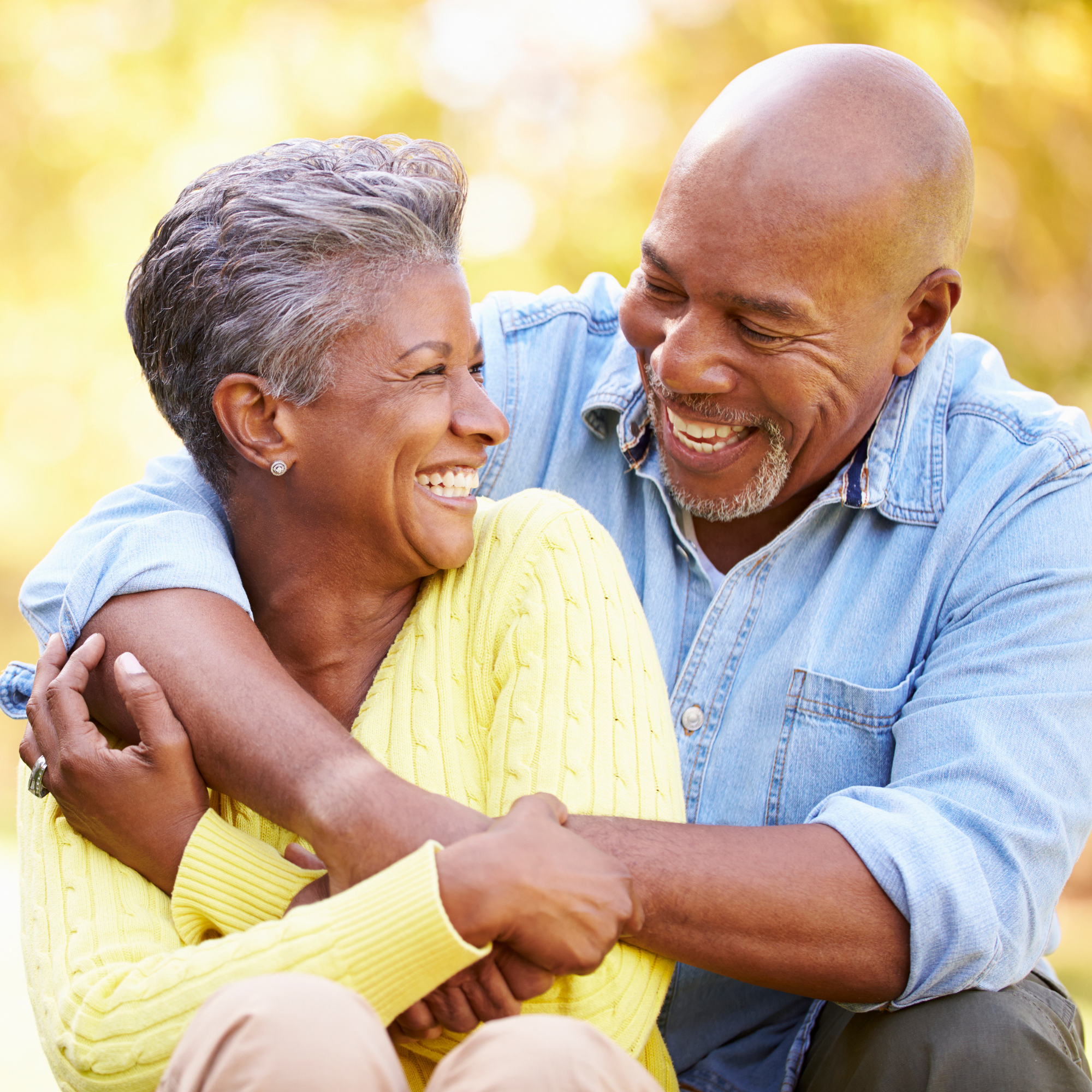 Older couple embracing in a side hug smiling at each other because they attended our homebuyer webinar